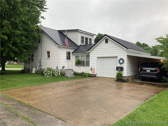 301 Burke St, Versailles, MO 65084 - view of front of house with a front lawn, metal roof, a garage, and concrete driveway