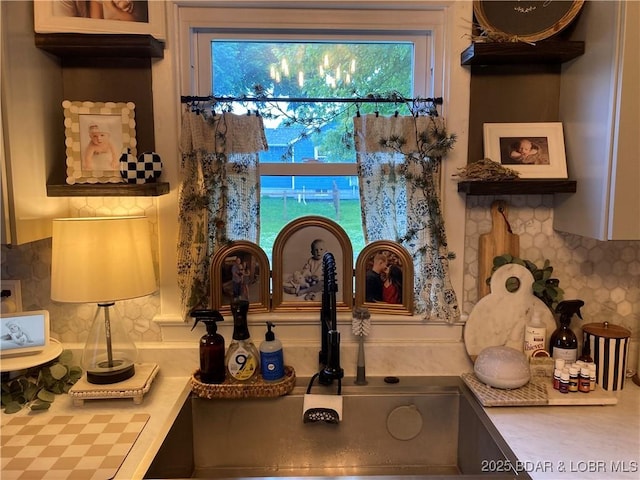 301 Burke St, Versailles, MO 65084 - kitchen view of backsplash, light countertops, and a sink