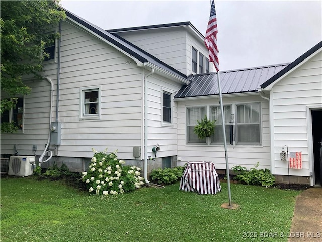 301 Burke St, Versailles, MO 65084 - view of home's exterior featuring a lawn, a cooling unit, and metal roof