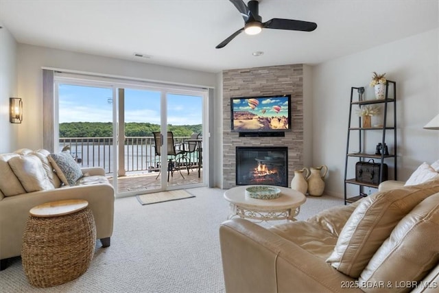 4800 Eagleview Dr Unit 115B, Osage Beach, MO 65065 - living area with carpet, a ceiling fan, and a stone fireplace