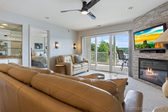 4800 Eagleview Dr Unit 115B, Osage Beach, MO 65065 - living area with a fireplace, a ceiling fan, and carpet floors