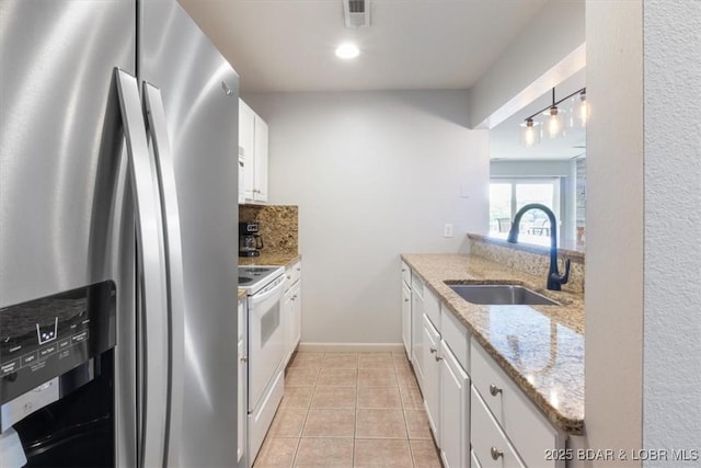 4800 Eagleview Dr Unit 115B, Osage Beach, MO 65065 - kitchen with stainless steel fridge, a sink, white electric range oven, white cabinetry, and light tile patterned floors