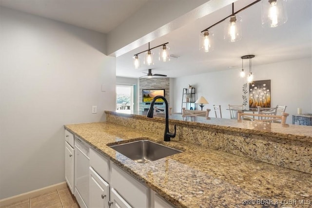 4800 Eagleview Dr Unit 115B, Osage Beach, MO 65065 - kitchen with a sink, ceiling fan, a large fireplace, white cabinetry, and light tile patterned floors
