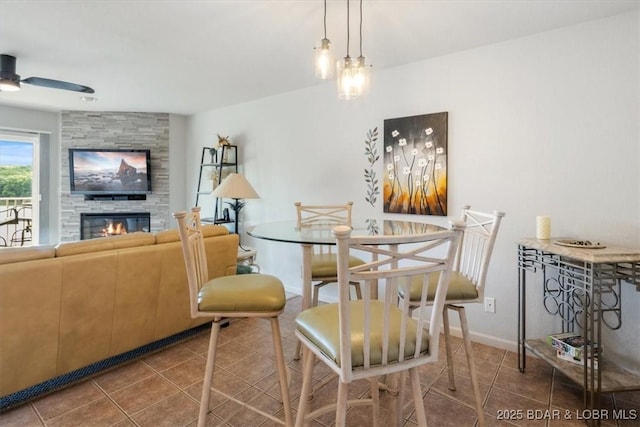 4800 Eagleview Dr Unit 115B, Osage Beach, MO 65065 - dining space with tile patterned flooring, a ceiling fan, and a large fireplace