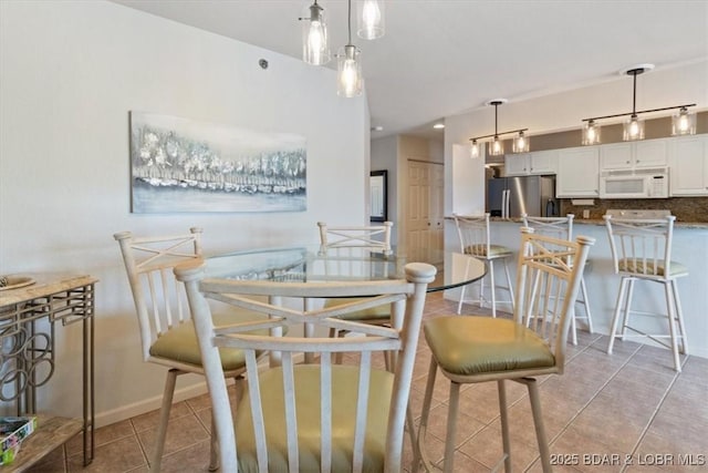4800 Eagleview Dr Unit 115B, Osage Beach, MO 65065 - dining space featuring light tile patterned floors and baseboards