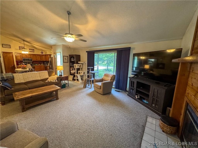 104 Tower View Dr, Versailles, MO 65084 - living area with a fireplace, vaulted ceiling, ceiling fan, carpet floors, and a textured ceiling