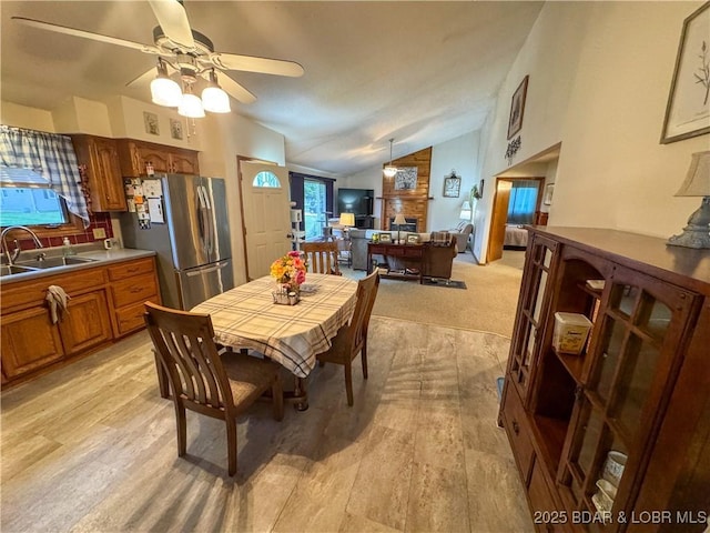 104 Tower View Dr, Versailles, MO 65084 - dining space featuring vaulted ceiling, ceiling fan, and a large fireplace