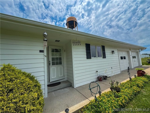 104 Tower View Dr, Versailles, MO 65084 - doorway to property featuring a garage