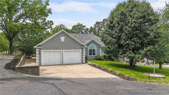 166 Joy Cir, Camdenton, MO 65020 - view of front facade with concrete driveway, a front lawn, a garage, and stucco siding
