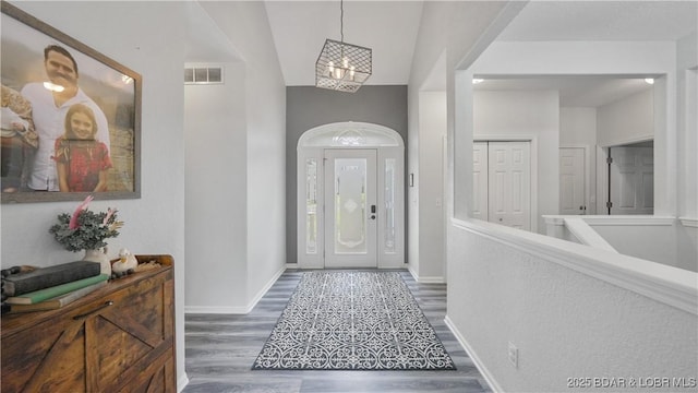 166 Joy Cir, Camdenton, MO 65020 - entrance foyer with wood finished floors, a chandelier, and baseboards