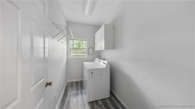 166 Joy Cir, Camdenton, MO 65020 - laundry area featuring cabinet space, independent washer and dryer, dark wood-style flooring, and baseboards