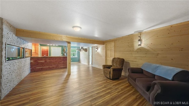 166 Joy Cir, Camdenton, MO 65020 - living room featuring wooden walls, wood finished floors, and a textured ceiling