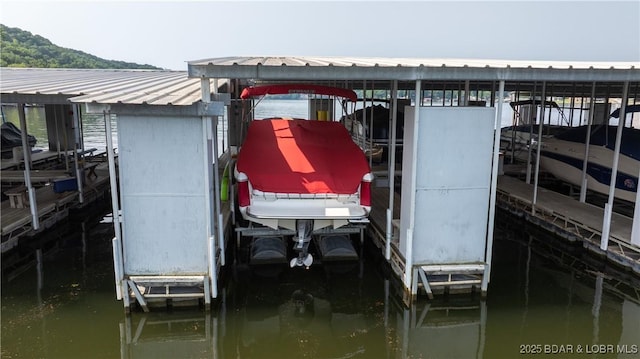 149 Sycamore Beach Rd Unit C1, Camdenton, MO 65020 - dock featuring boat lift and a water view