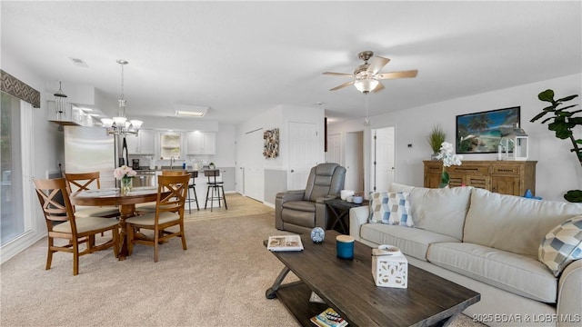 149 Sycamore Beach Rd Unit C1, Camdenton, MO 65020 - living area with a chandelier, ceiling fan, and light colored carpet