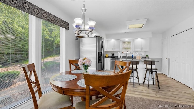 149 Sycamore Beach Rd Unit C1, Camdenton, MO 65020 - dining area with a chandelier and light wood-type flooring