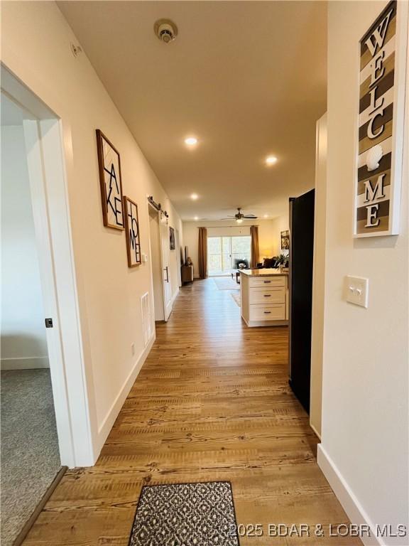 295 Highland Shores Dr Unit 2D, Lake Ozark, MO 65049 - hallway featuring light wood-type flooring, baseboards, and recessed lighting