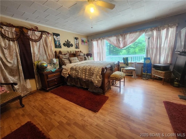 159 Tonka Shady Ln, Camdenton, MO 65020 - bedroom with wood finished floors, ornamental molding, and ceiling fan