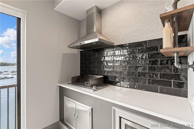 1184 Jeffries Rd Unit 312, Osage Beach, MO 65065 - kitchen with island range hood, tasteful backsplash, open shelves, and stovetop