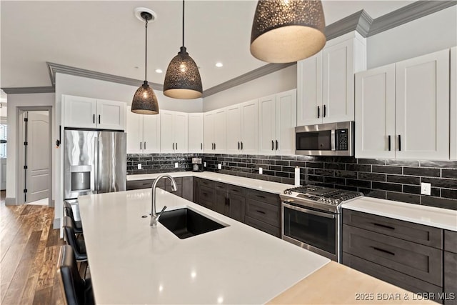 1184 Jeffries Rd Unit 312, Osage Beach, MO 65065 - kitchen with stainless steel appliances, a sink, ornamental molding, light countertops, and white cabinets