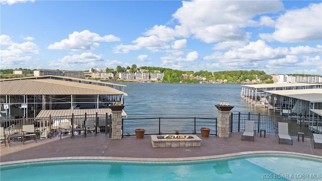 1184 Jeffries Rd Unit 312, Osage Beach, MO 65065 - view of swimming pool featuring an outdoor fire pit, a patio area, and a water view