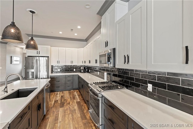 1184 Jeffries Rd Unit 312, Osage Beach, MO 65065 - kitchen with stainless steel appliances, a sink, light countertops, white cabinets, and ornamental molding