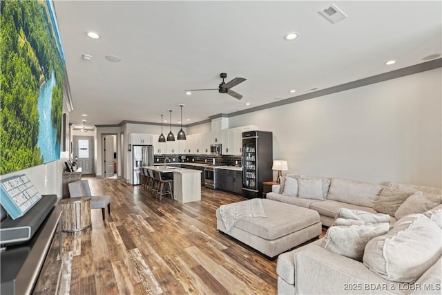 1184 Jeffries Rd Unit 312, Osage Beach, MO 65065 - living room featuring crown molding, a ceiling fan, recessed lighting, and dark wood finished floors