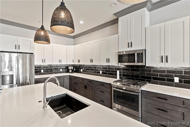 1184 Jeffries Rd Unit 312, Osage Beach, MO 65065 - kitchen with stainless steel appliances, a sink, light countertops, and crown molding