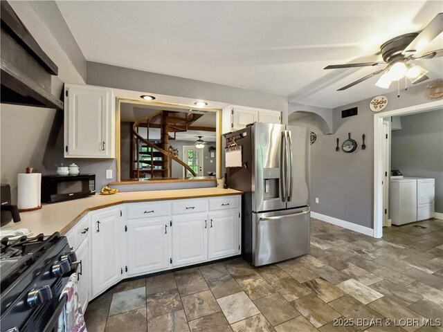 75 Central Hill Rd, Eldon, MO 65026 - kitchen with stainless steel fridge, a ceiling fan, washing machine and dryer, black microwave, and gas stove