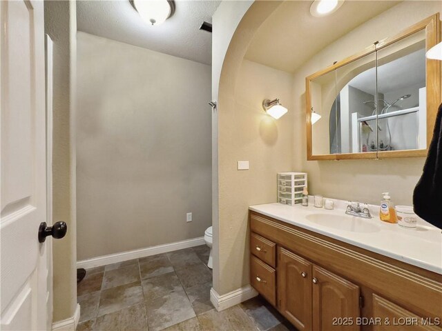 75 Central Hill Rd, Eldon, MO 65026 - full bathroom featuring toilet, vanity, baseboards, and a shower