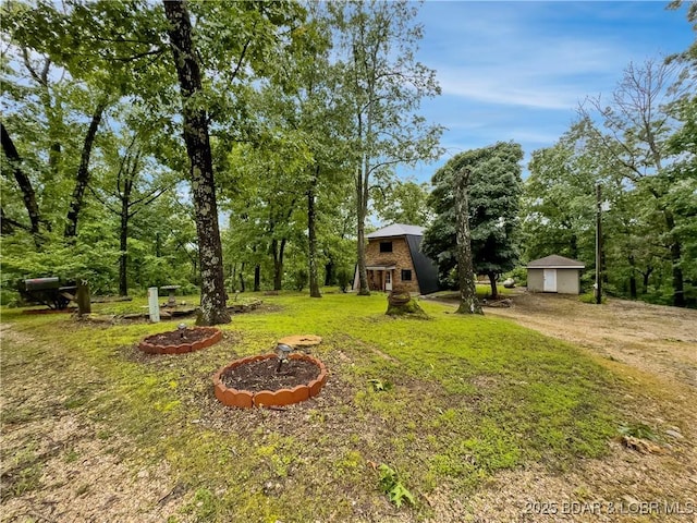 75 Central Hill Rd, Eldon, MO 65026 - view of green lawn featuring a detached garage and an outbuilding