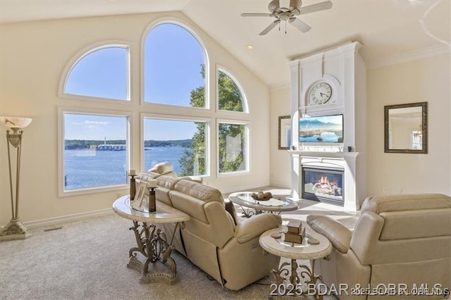 549 Cedar Rd, Lake Ozark, MO 65049 - living area featuring a glass covered fireplace, a ceiling fan, high vaulted ceiling, baseboards, and carpet