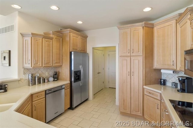 549 Cedar Rd, Lake Ozark, MO 65049 - kitchen featuring stainless steel appliances, recessed lighting, light countertops, a sink, and backsplash