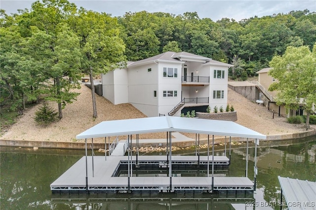 80 Ledgestone Estates Ct, Sunrise Beach, MO 65079 - dock featuring a water view, a wooded view, stairs, and boat lift