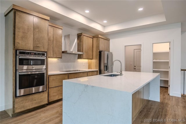 80 Ledgestone Estates Ct, Sunrise Beach, MO 65079 - kitchen with wall chimney range hood, stainless steel appliances, light wood-type flooring, modern cabinets, and an island with sink