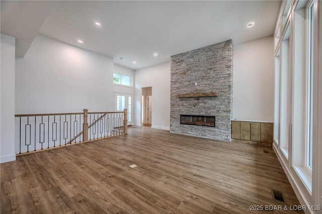 80 Ledgestone Estates Ct, Sunrise Beach, MO 65079 - unfurnished living room with wood finished floors, a fireplace, and recessed lighting