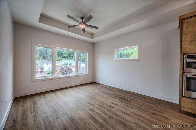 80 Ledgestone Estates Ct, Sunrise Beach, MO 65079 - unfurnished room with a tray ceiling, wood finished floors, and ceiling fan