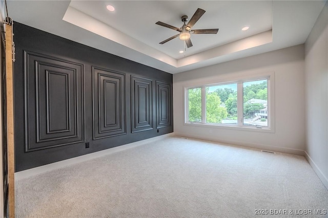 80 Ledgestone Estates Ct, Sunrise Beach, MO 65079 - spare room with a tray ceiling, carpet floors, a ceiling fan, and recessed lighting