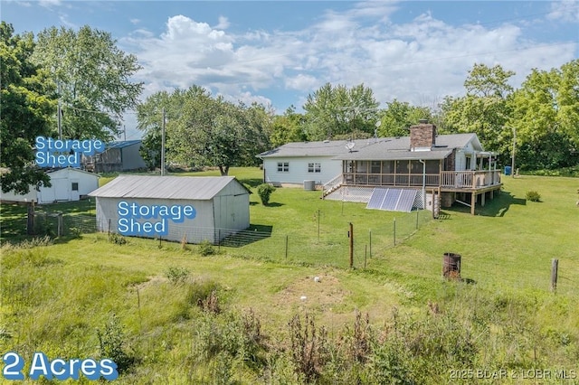 15852 Kindling Rd, Eldridge, MO 65463 - back of house with a sunroom, a wooden deck, and a chimney