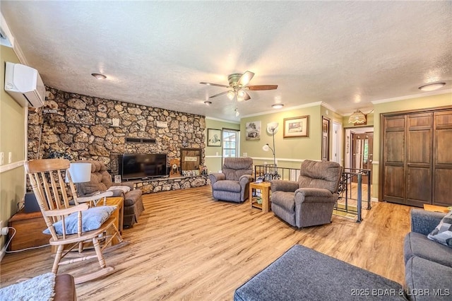 15852 Kindling Rd, Eldridge, MO 65463 - living area featuring a wall mounted AC, crown molding, a ceiling fan, light wood finished floors, and a textured ceiling