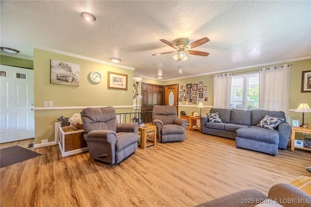 15852 Kindling Rd, Eldridge, MO 65463 - living room with wood finished floors, crown molding, ceiling fan, and a textured ceiling
