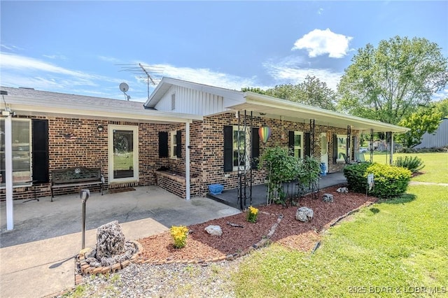 15852 Kindling Rd, Eldridge, MO 65463 - view of front of home with brick siding, a front lawn, and covered porch