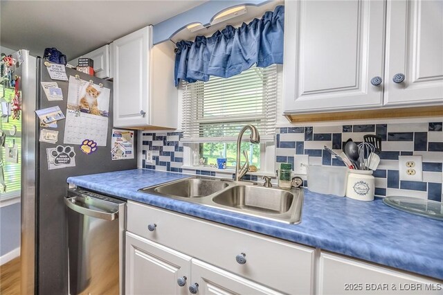 15852 Kindling Rd, Eldridge, MO 65463 - kitchen with a sink, white cabinets, dishwasher, and tasteful backsplash