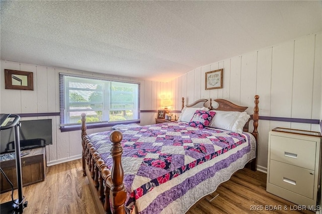 15852 Kindling Rd, Eldridge, MO 65463 - bedroom with wood finished floors, baseboards, and a textured ceiling