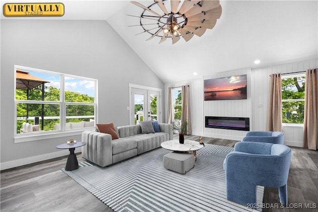 64 Oriole Ct, Lake Ozark, MO 65049 - living area featuring a glass covered fireplace, high vaulted ceiling, wood finished floors, baseboards, and recessed lighting