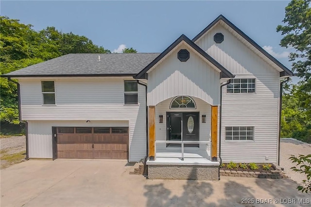 64 Oriole Ct, Lake Ozark, MO 65049 - view of front facade featuring a garage and driveway