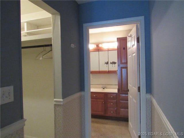 bathroom with vanity and wainscoting
