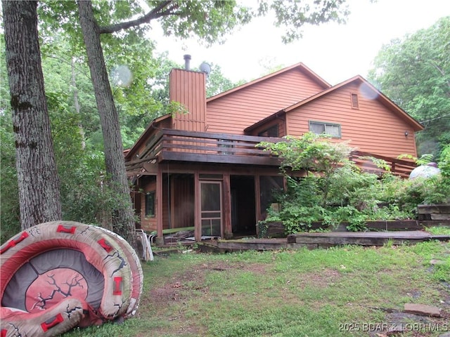 back of house featuring a chimney