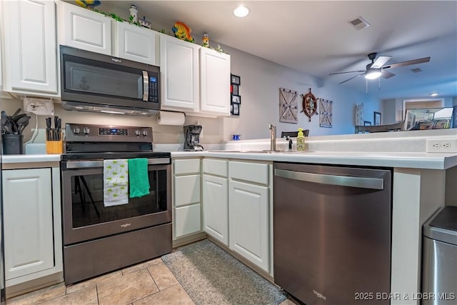 549 Park Place Dr Unit 2D, Kaiser, MO 65047 - kitchen featuring appliances with stainless steel finishes, a peninsula, light countertops, white cabinets, and ceiling fan