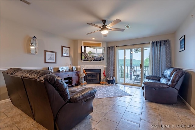 549 Park Place Dr Unit 2D, Kaiser, MO 65047 - living area featuring ceiling fan, baseboards, a tile fireplace, and light tile patterned floors