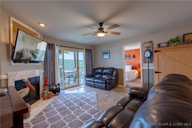549 Park Place Dr Unit 2D, Kaiser, MO 65047 - living area featuring ceiling fan, a high end fireplace, baseboards, and stone finish floors